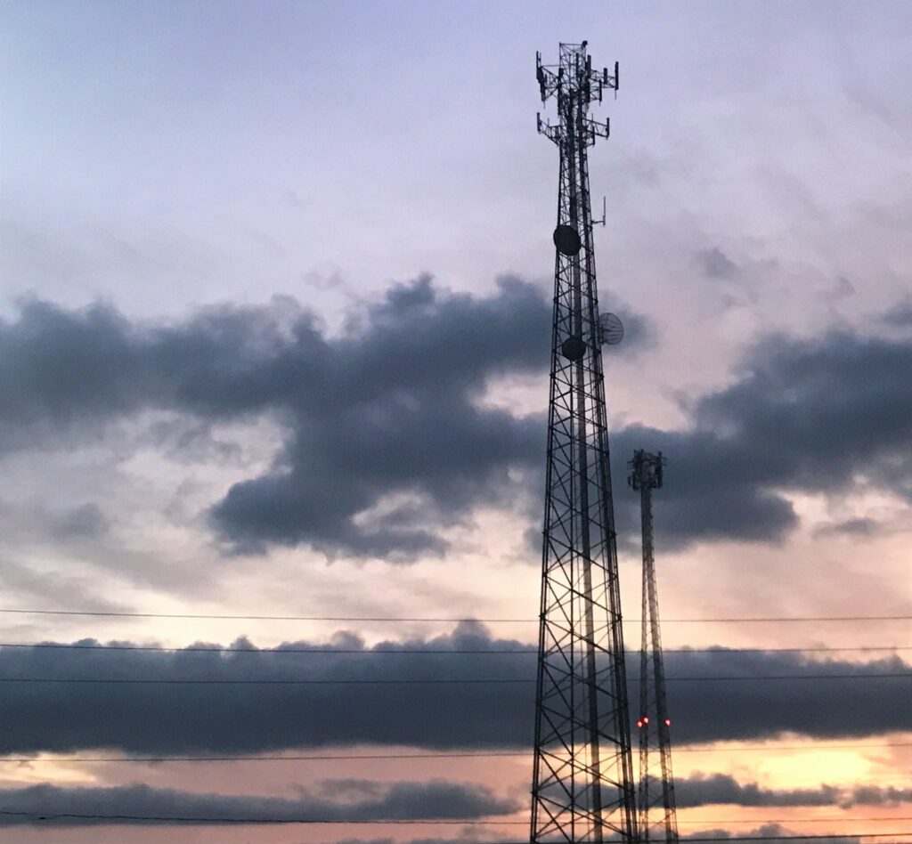 a radio tower against a sunrise